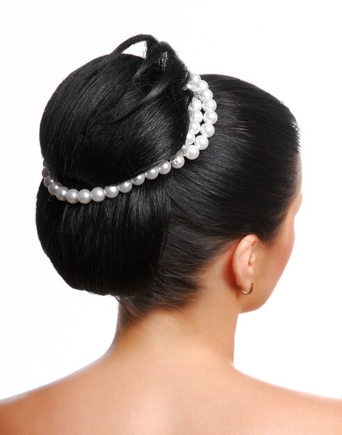 Rear view of a stylish modern wedding hairstyle with pearls  isolated on white