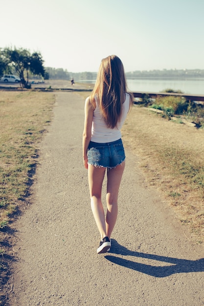 Rear view of teenager walking