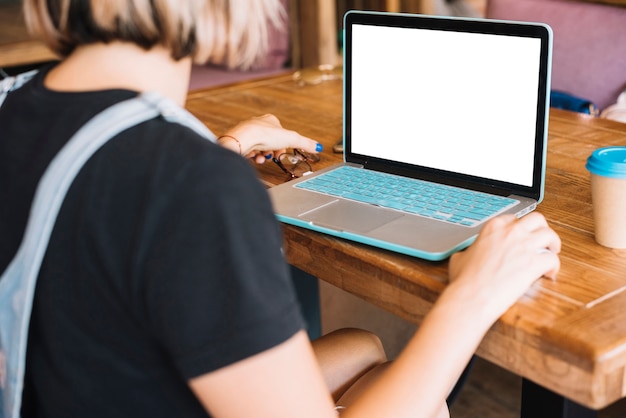 Rear view of woman browsing laptop