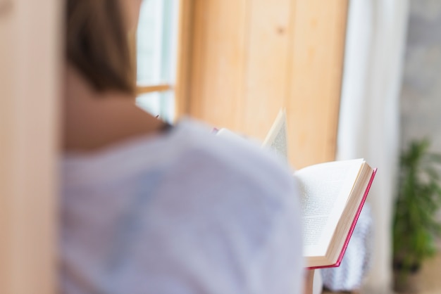 Rear view of woman reading book