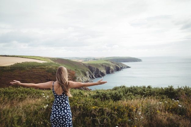 Rear view woman standing with arms outstretched