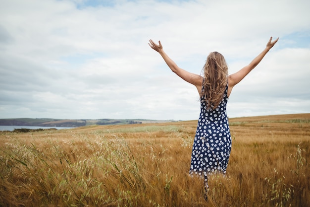 Rear view woman standing with arms outstretched