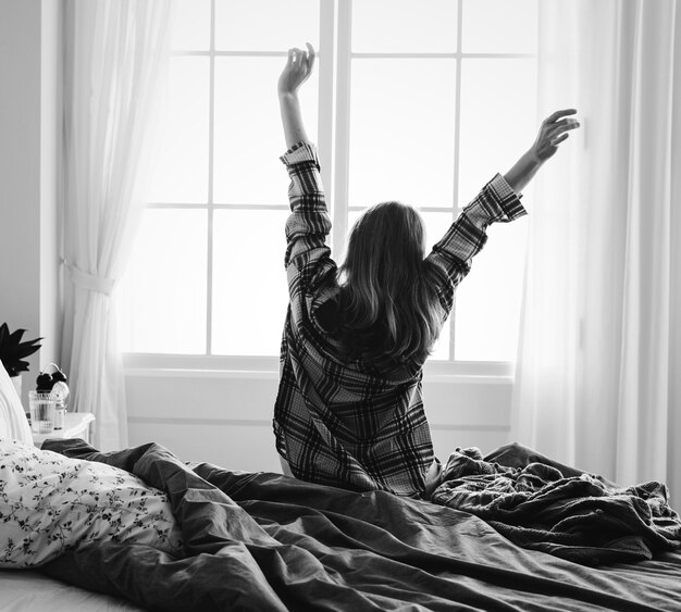 Rear view of woman stretching her arms in the morning