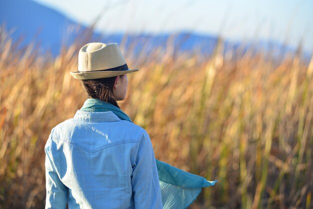 Rear view of woman with hat contemplating the nature