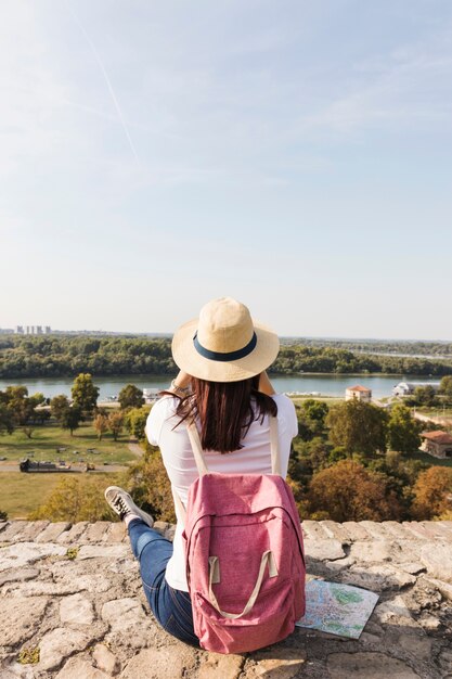 Rear view of a woman with rucksack looking at view