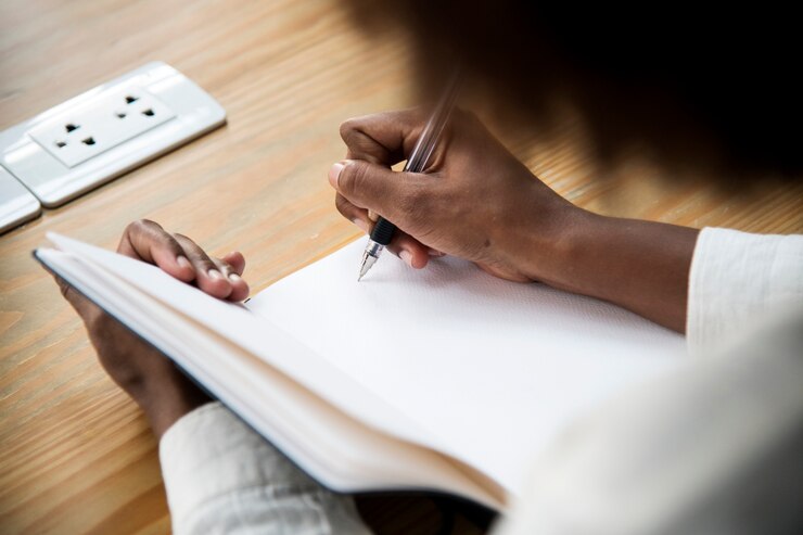 Free Photo rear view of woman writing a note