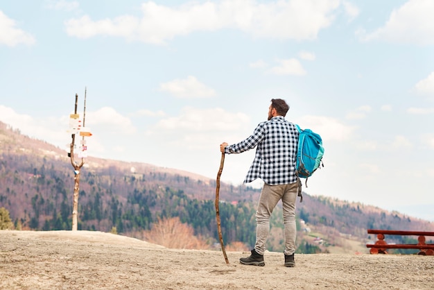 rear view of young man with backpack traveling