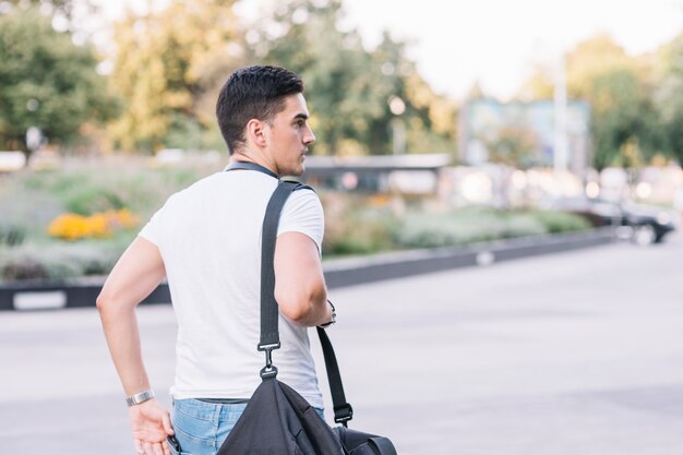 Rear view of a young man with bag