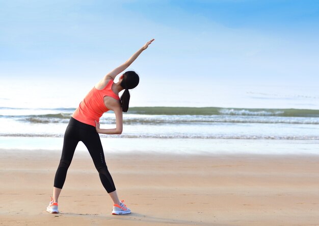 Rear view of young woman doing warm-ups