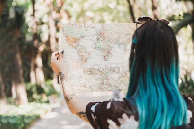 Rear view of young woman looking at map