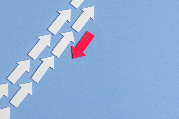 rebel red arrow and crowd of white arrows on blue background