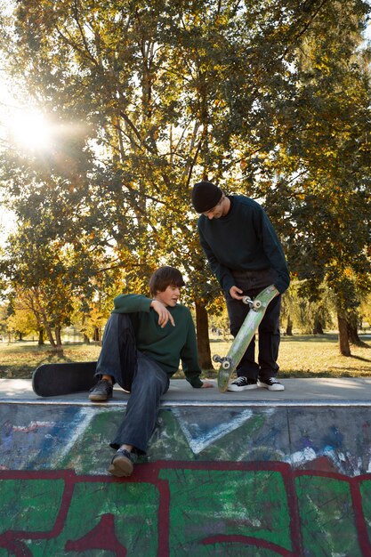 Rebel teens with skateboard full shot