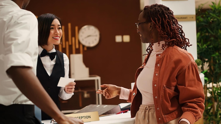 Free Photo receptionist handing couple room key