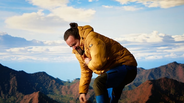reckless unprepared hiker stumbles near the edge of a high altitude cliff