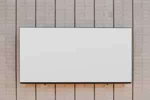 Free photo rectangular white blank billboard on striped wall