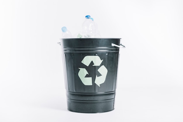 Recycle bucket with plastic bottles on white background