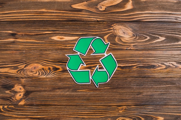 Recycle icon on wooden textured backdrop