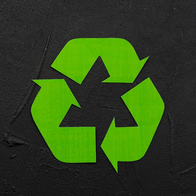 Recycle logo on black plaster background
