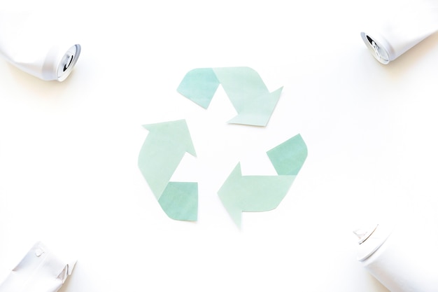 Recycle logo with garbage in corners 