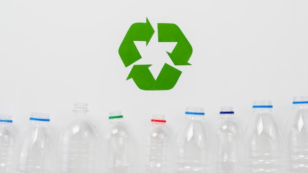 Recycle symbol and  plastic bottles on grey backgound