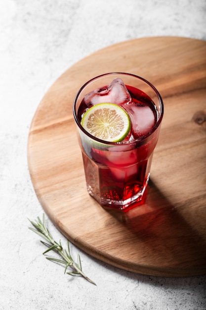 Red alcoholic cocktail with lemon