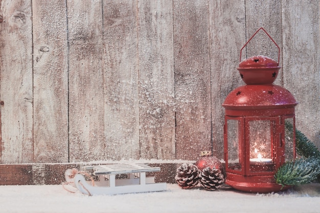 Red antique lamp with a burning candle