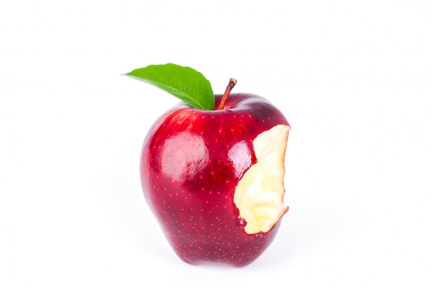 Red apple with green leaf and missing a bite .