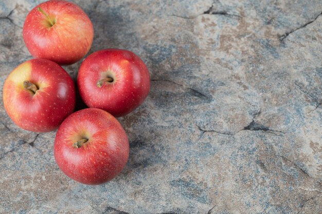 Red apples isolated on concrete.