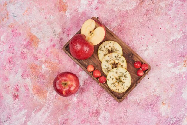 Mele rosse affettate sulla tavola di legno.