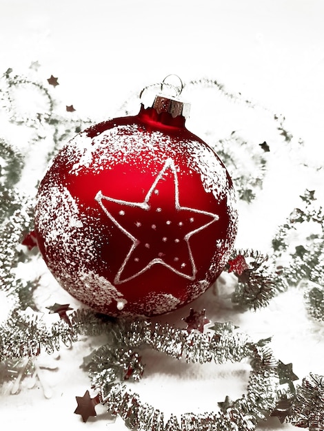red ball Christmas ornament with silver tinsel