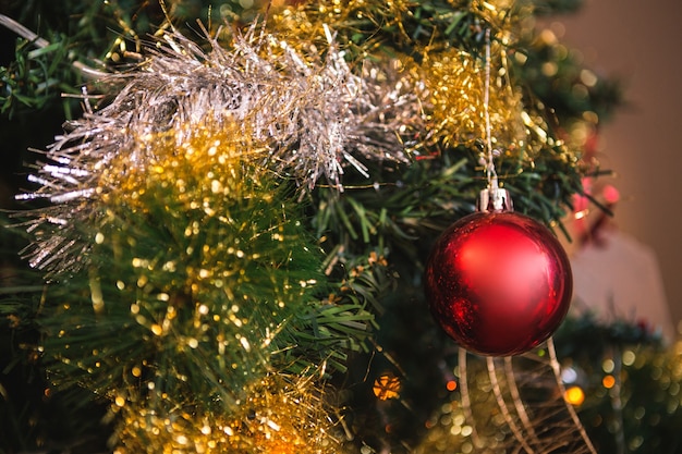 Red ball hanging from a christmas tree