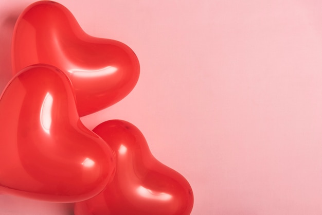 Red balloons on pink background with copy space