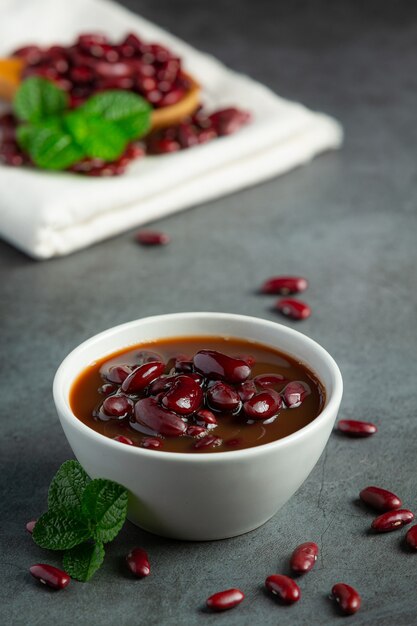 red bean boiled in white bowl place on dark floor