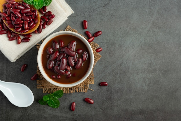 red bean boiled in white bowl place on dark floor