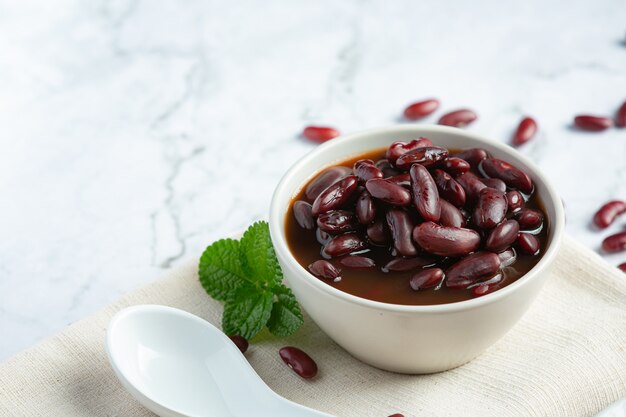 red bean boiled in white bowl place on white marble floor