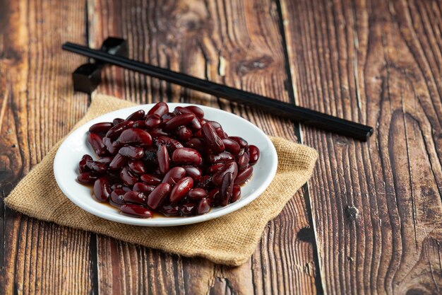 red bean boiled in white plate place on wooden floor