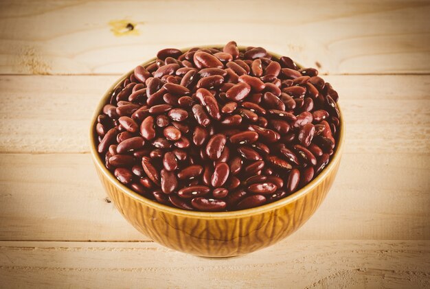 red  beans on wood background - soft focus with vintage film filter