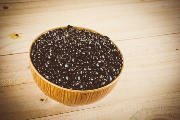 red  beans on wood background - soft focus with vintage film filter