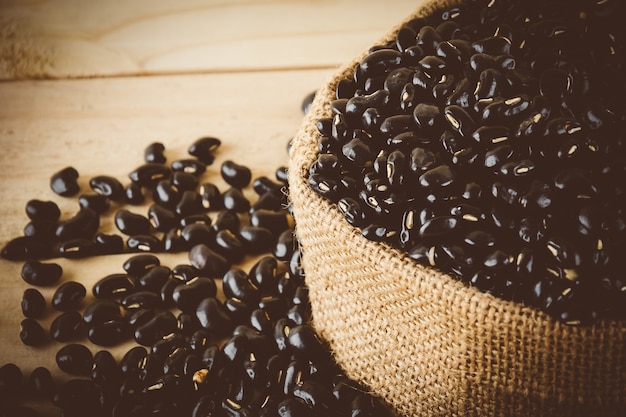 red  beans on wood background - soft focus with vintage film filter