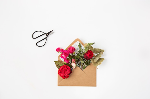 Red beautiful roses in envelope