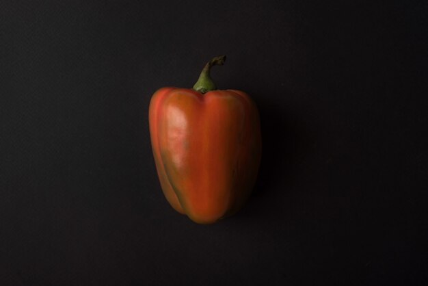 Red bell pepper over black