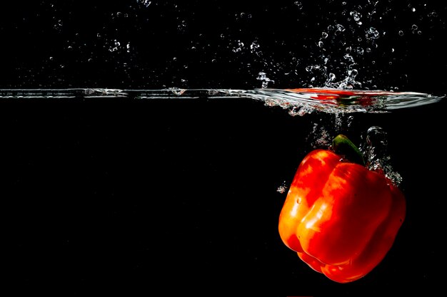 Red bell pepper floating under the clear water