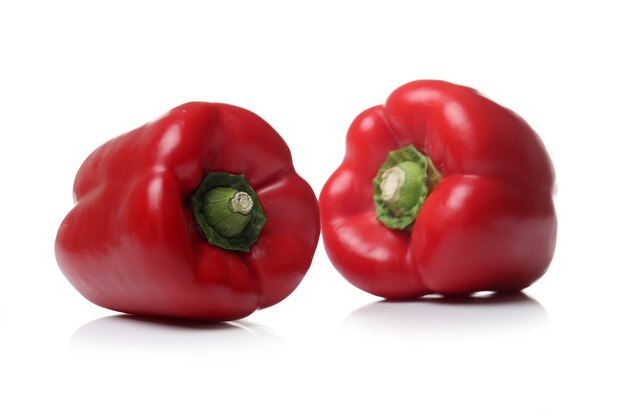 Red bell peppers on a white surface