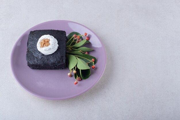 Red berry with brownies cake with walnut on plate on marble table.