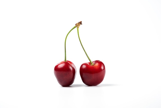 Red and black cherries on white background