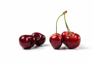 Free photo red and black cherries on white background