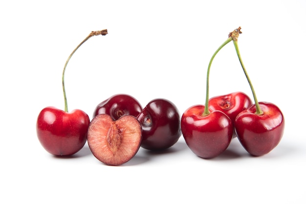 Red and black cherries on white background