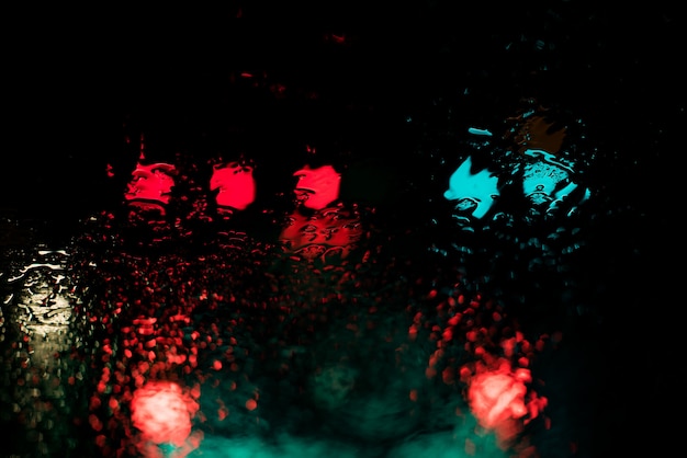 Red and blue lights reflecting through the body of water at nighttime