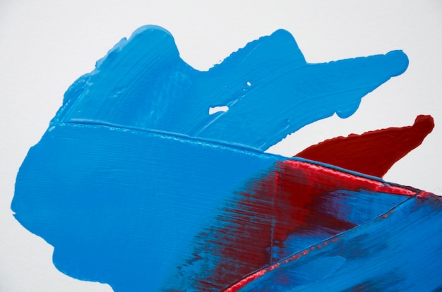 Red and blue paint on white background