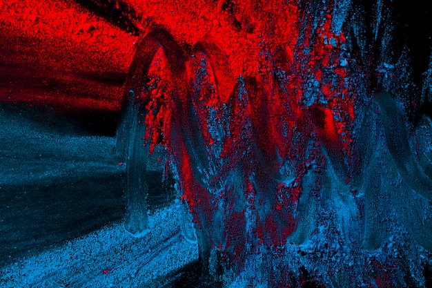Red and blue powder colors mixed with hand